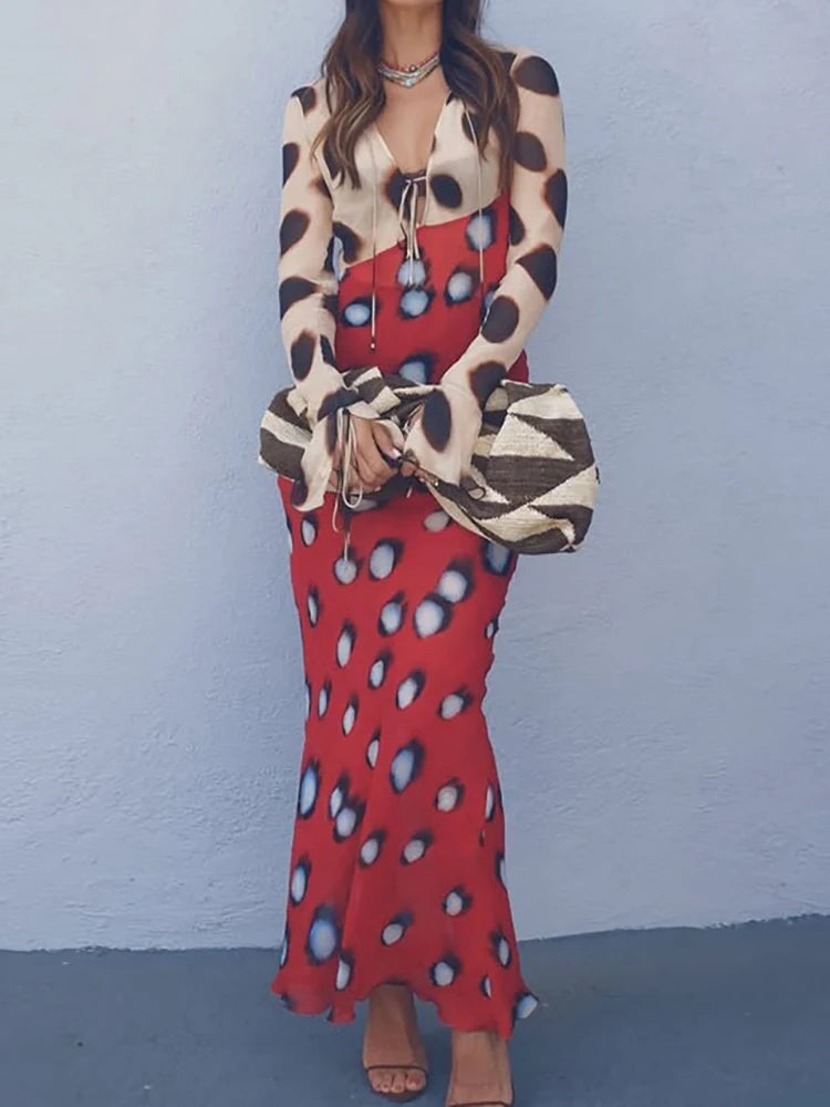 Model wearing a tie neck maxi dress with flare sleeves and a print.