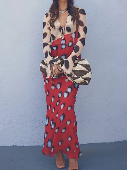 Model wearing a tie neck maxi dress with flare sleeves and a print.