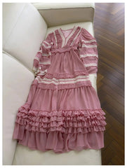Ruffled V-Neck Chiffon Maxi Dress laid out on a white sofa