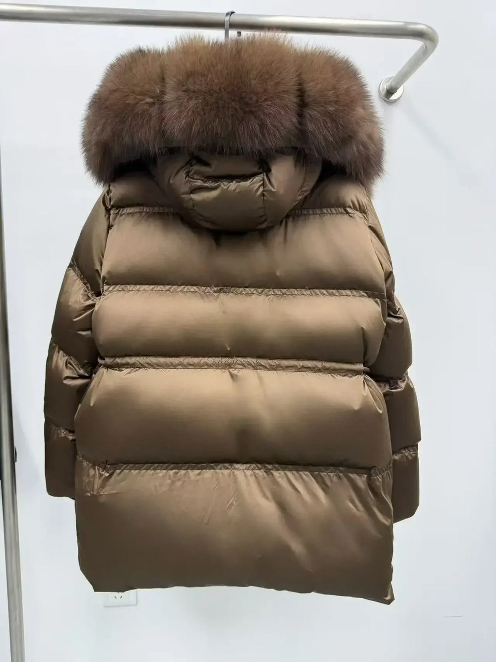 Brown puffer jacket with fur hood on a white background