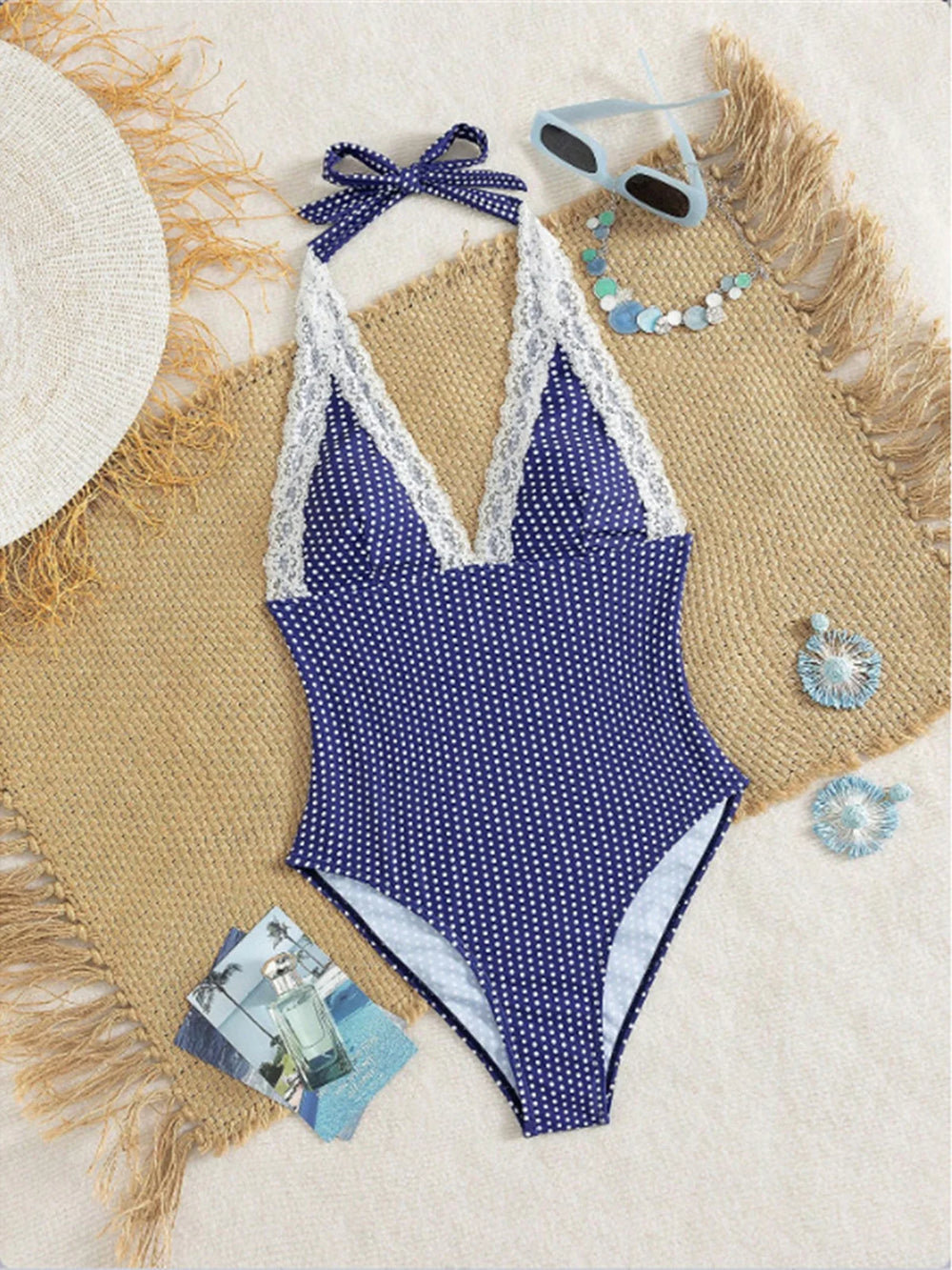Flat lay of polka dot one-piece swimwear with accessories
