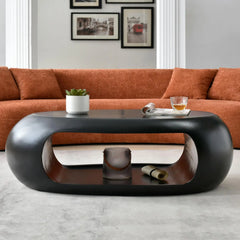 Modern living room with an orange sofa and a black coffee table.