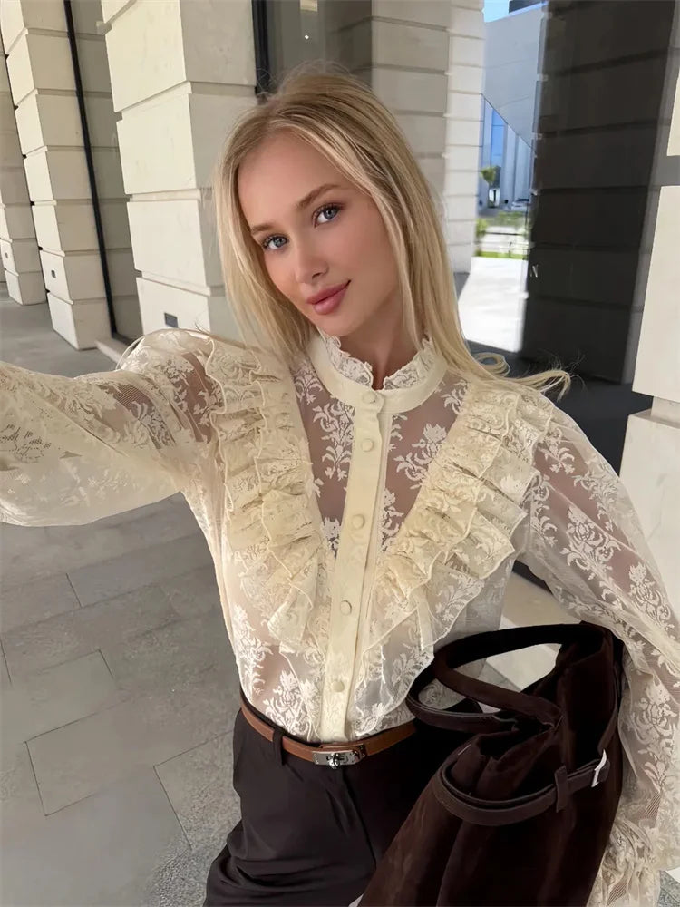 Woman wearing a sheer lace blouse with a blurred background