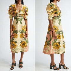 Woman wearing a floral dress with yellow and green flowers on a white background