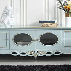 Light blue entertainment console with decorative elements in a room setting.
