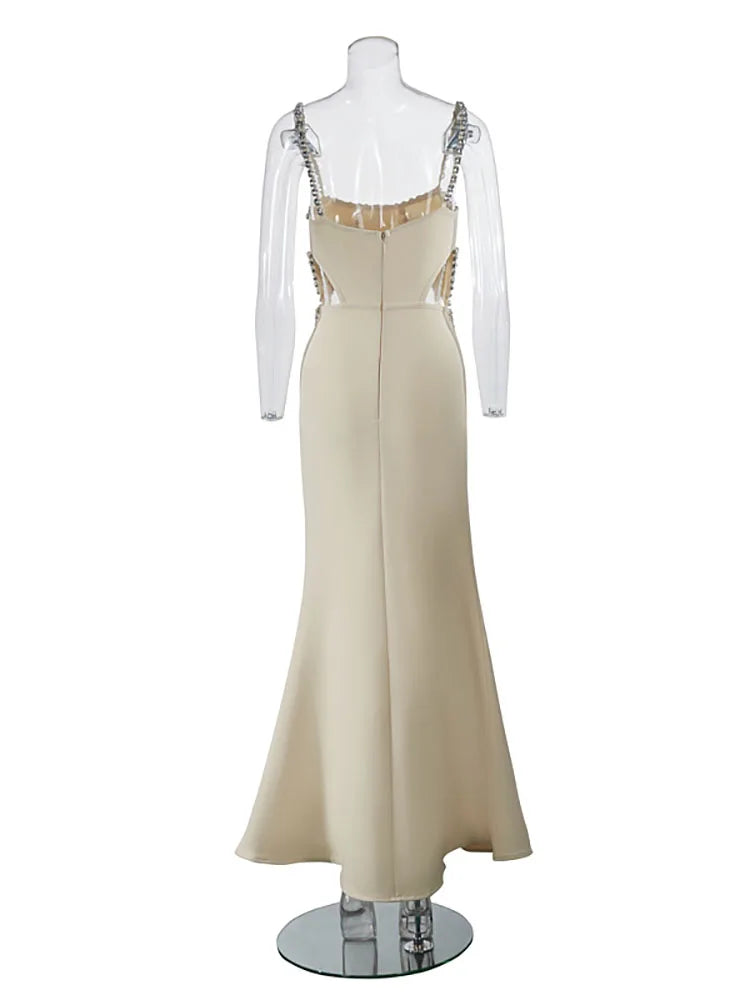 Beige evening gown with embellished straps on a mannequin against a white background
