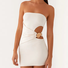 White strapless dress with a decorative button detail on a white background