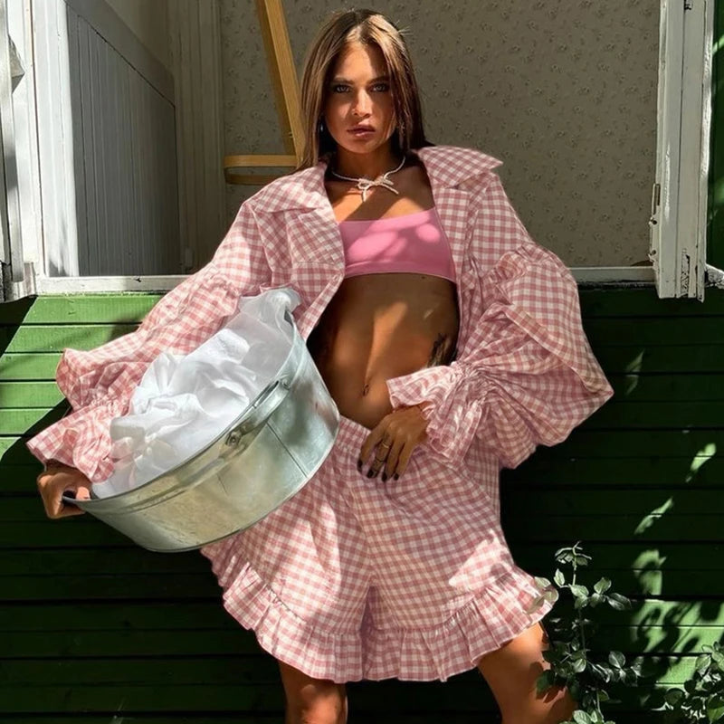 Woman in pink checkered outfit holding a laundry basket outdoors