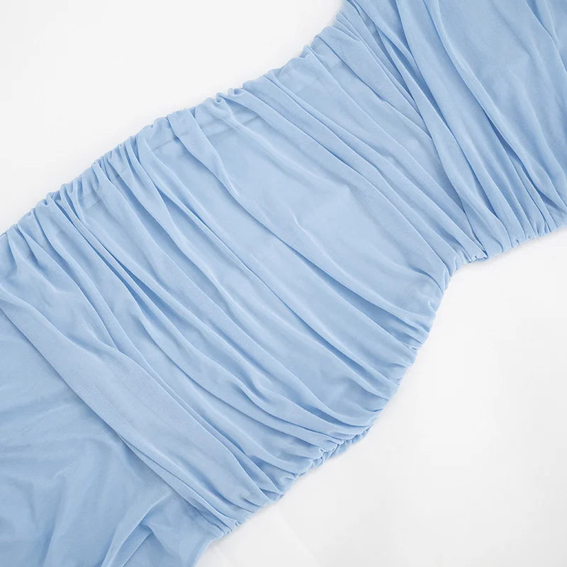 Light blue fitted sheet on a bed with a white background