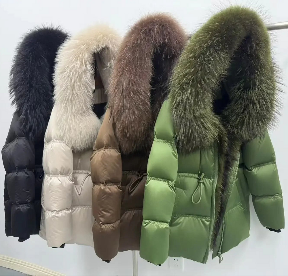 Four puffer jackets with fur hoods in different colors on a rack.