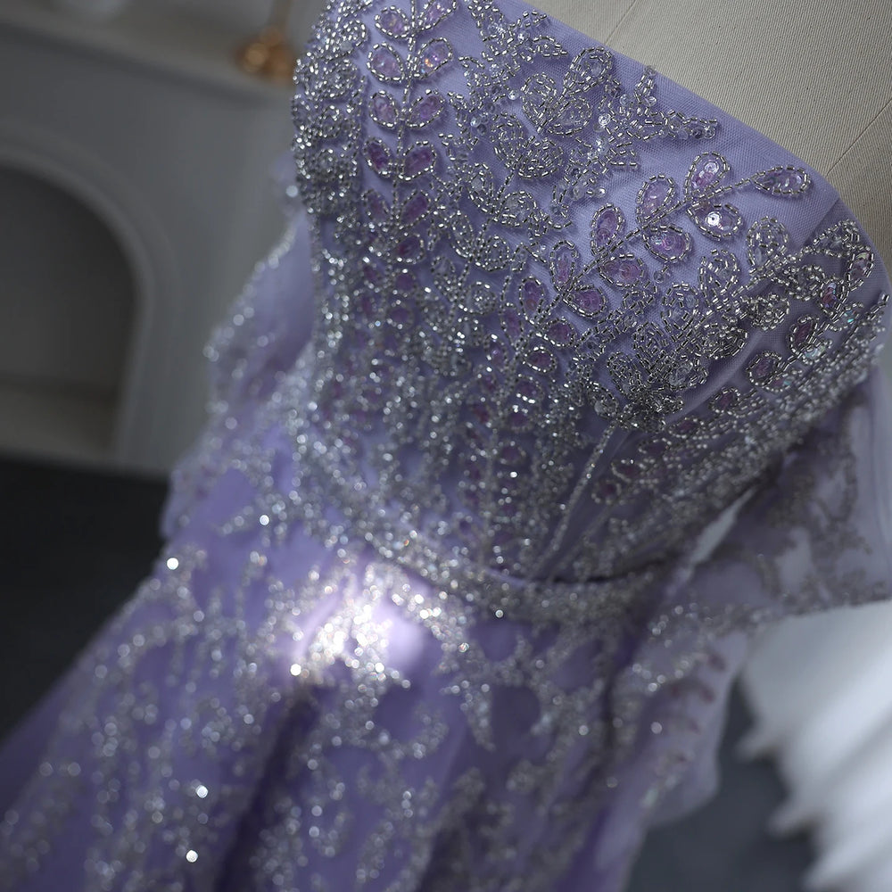 Close-up of a purple garment with intricate silver embroidery.