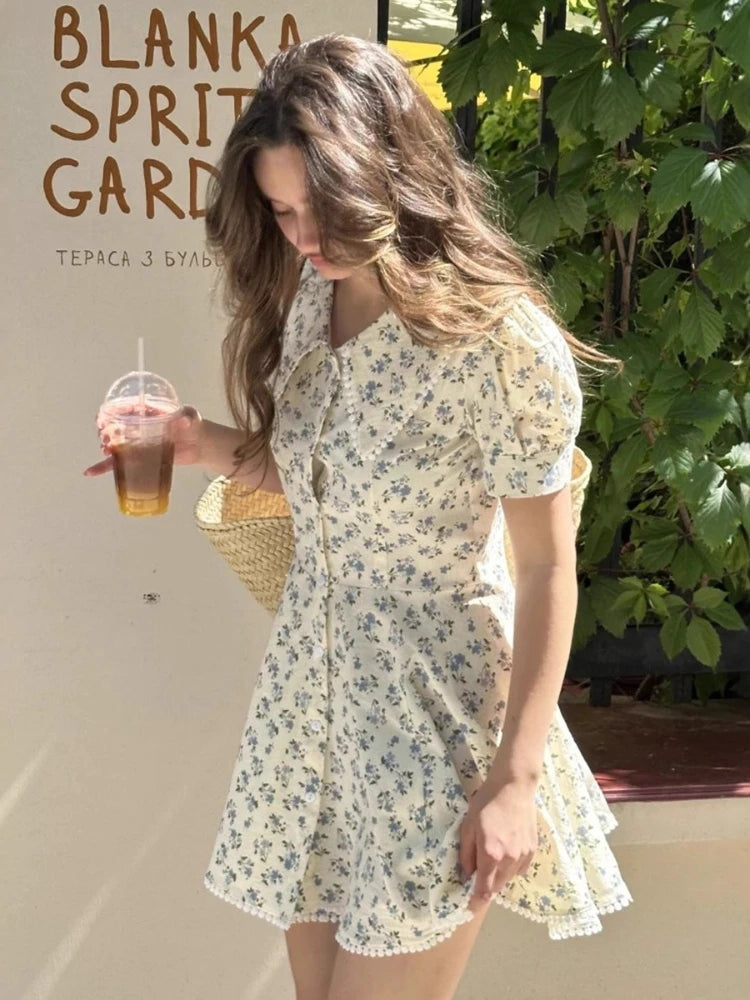 Woman in a floral dress holding a drink, with 'Blanka Spirit Garden' branding in the background.