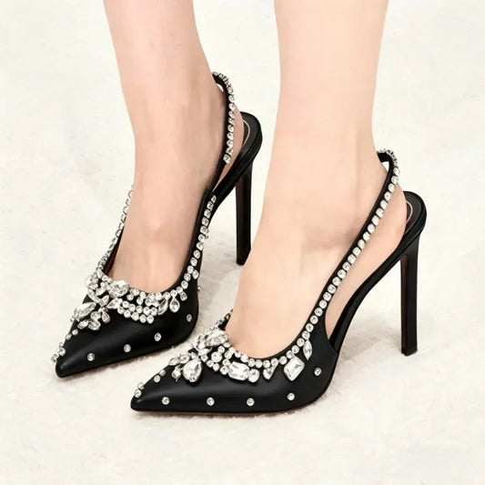 Pointed toe slingback pump adorned with crystals on a model's foot