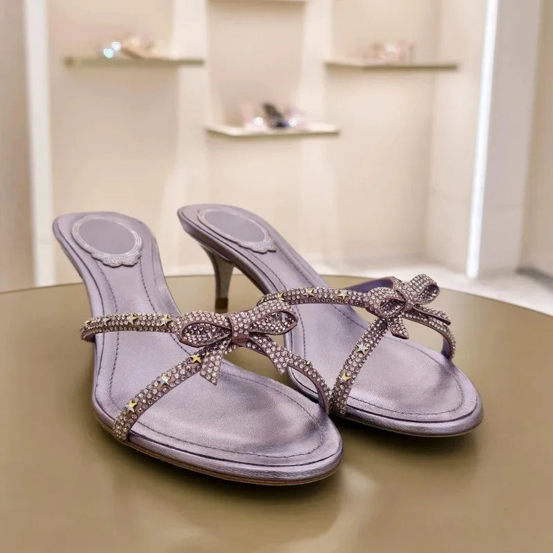 Bow embellished kitten heel sandals in a display