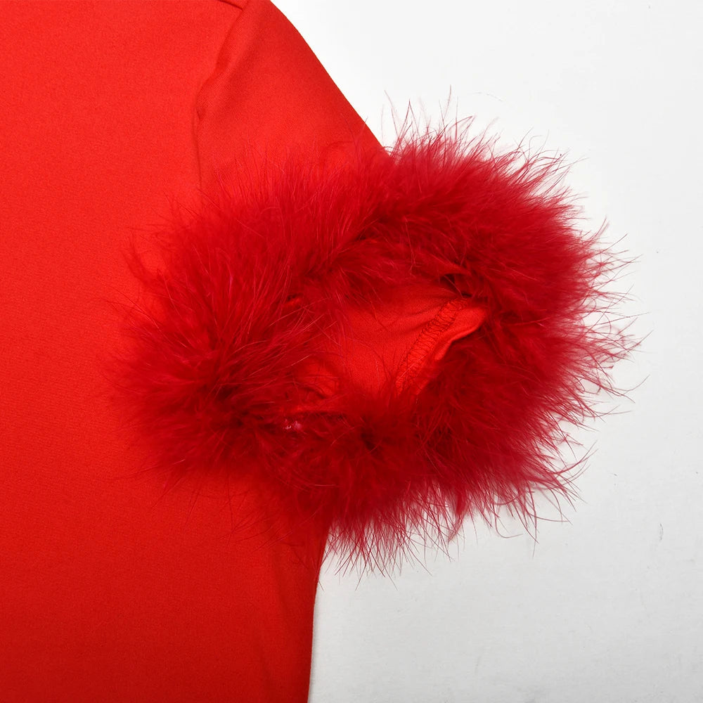 Close-up of a red garment with a fluffy pom-pom on a white background
