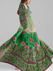 Green floral dress with pink flowers on a gray background