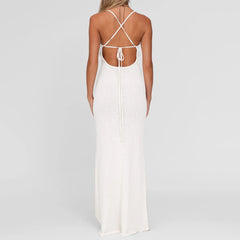 White dress with criss-cross back design on a plain background
