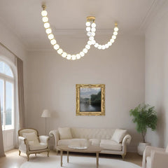  Contemporary chandelier illuminating a modern living room, creating a warm and inviting ambiance. Golden Atelier 2