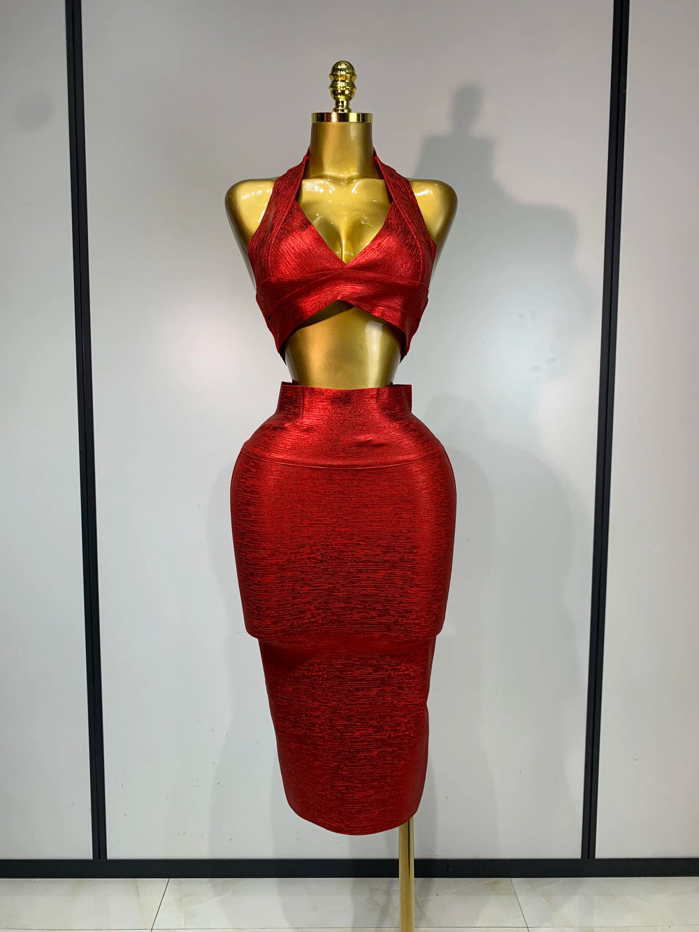 Metallic knit halter neck crop top and high-waisted midi skirt two-piece set, front view.