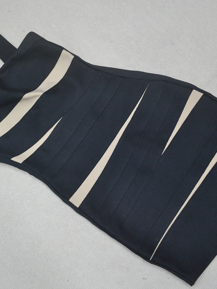 Black and beige striped dress on a light gray background