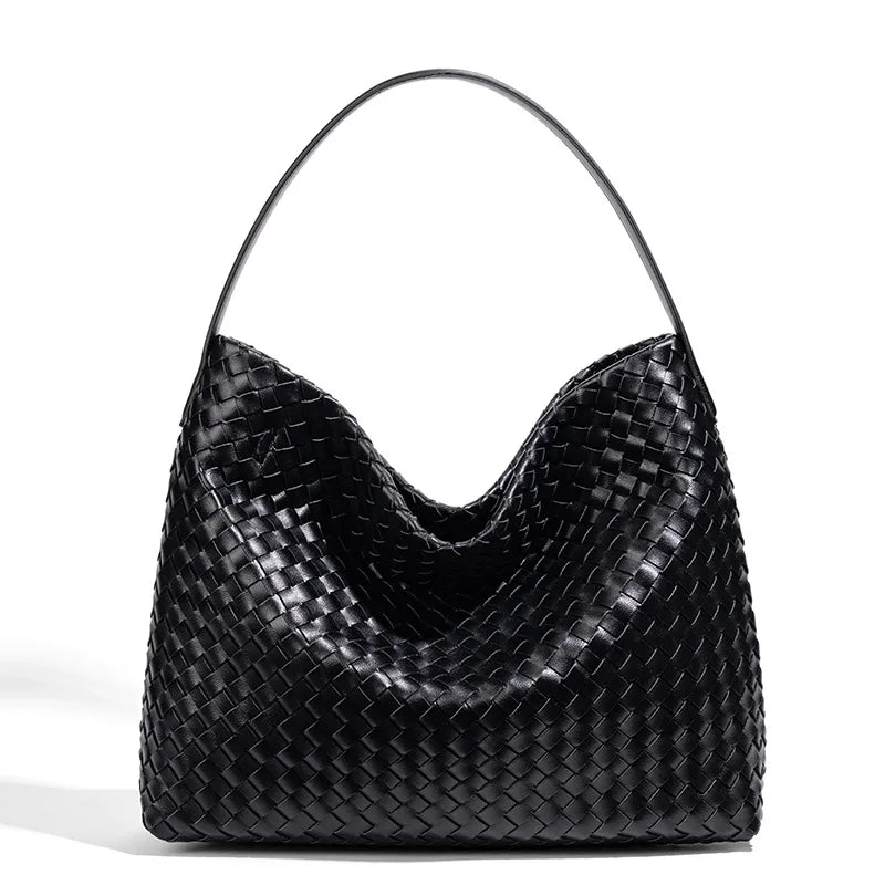 Black woven handbag on a white background