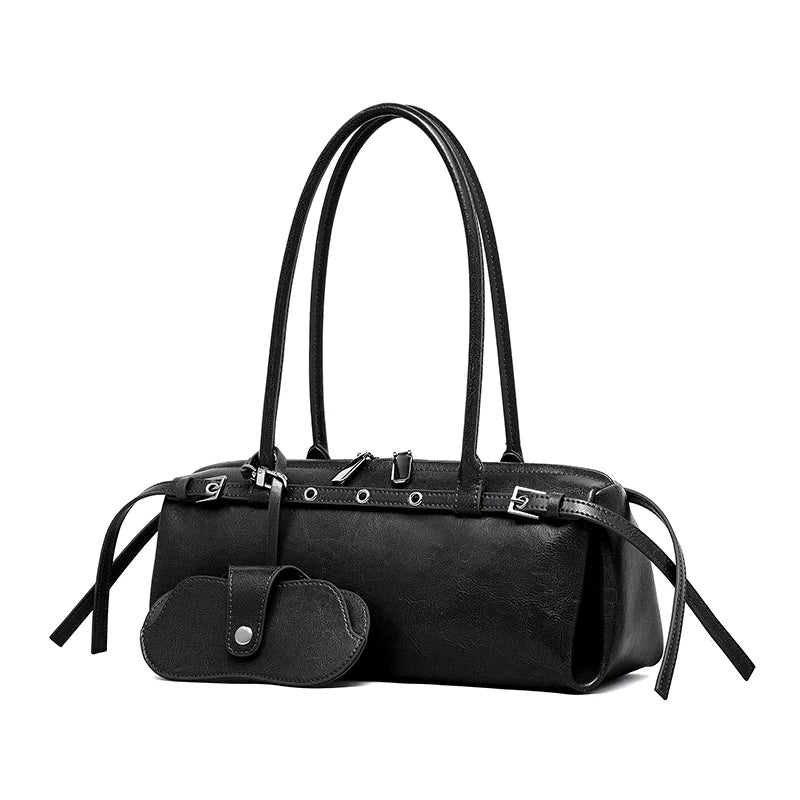 Black handbag with a strap and attached pouch on a white background