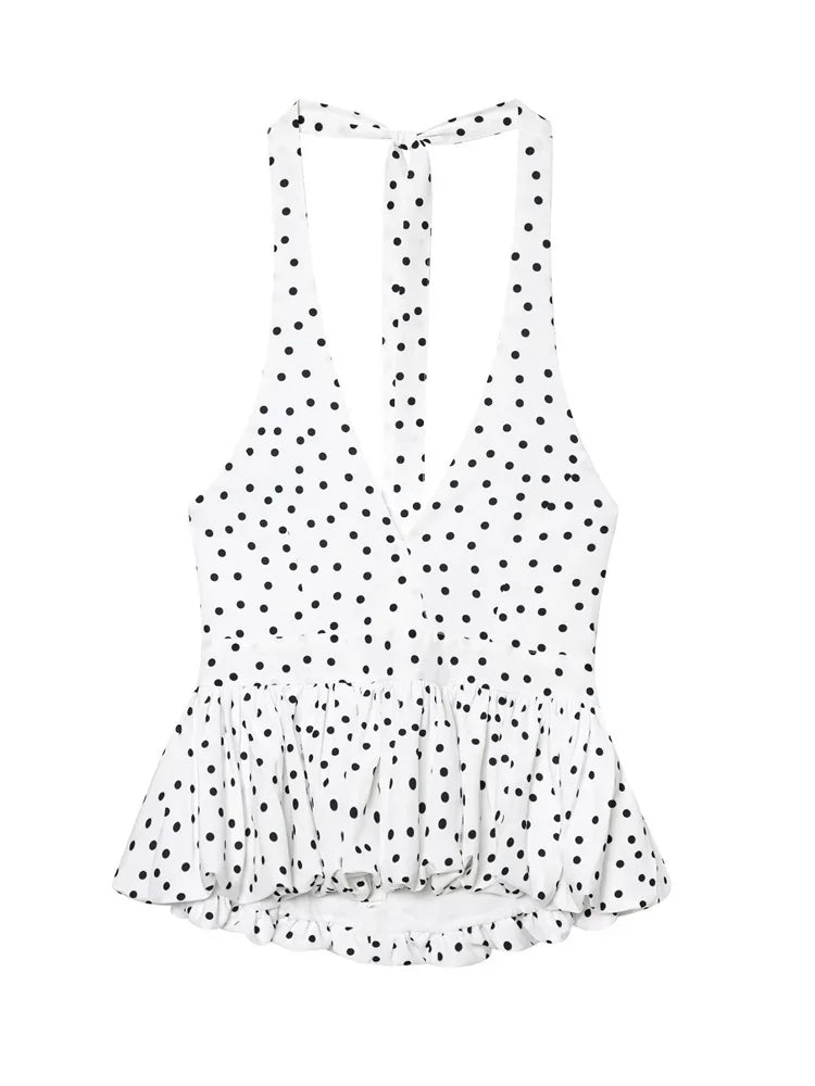 White sleeveless top with black polka dots on a white background
