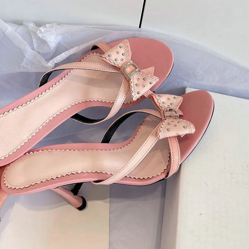 Pink bow accent heeled slides with stiletto heel