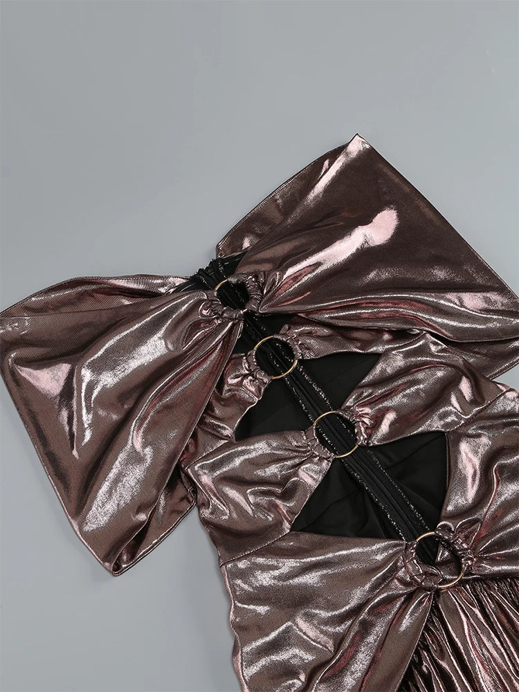 Metallic pink bow with black accents on a gray background