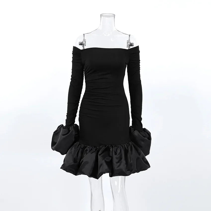 Black off-shoulder dress with ruffled skirt on a mannequin against a white background