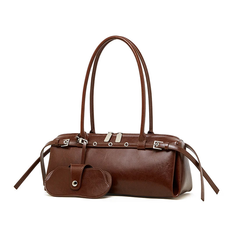 Brown leather handbag with multiple straps on a white background