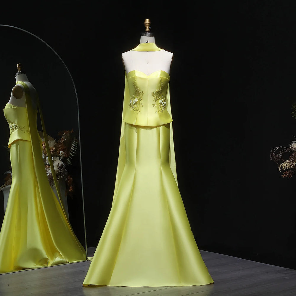 Yellow evening gown on a mannequin against a dark background