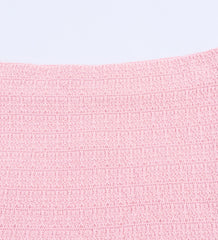 Close-up of a pink textured fabric on a light gray background