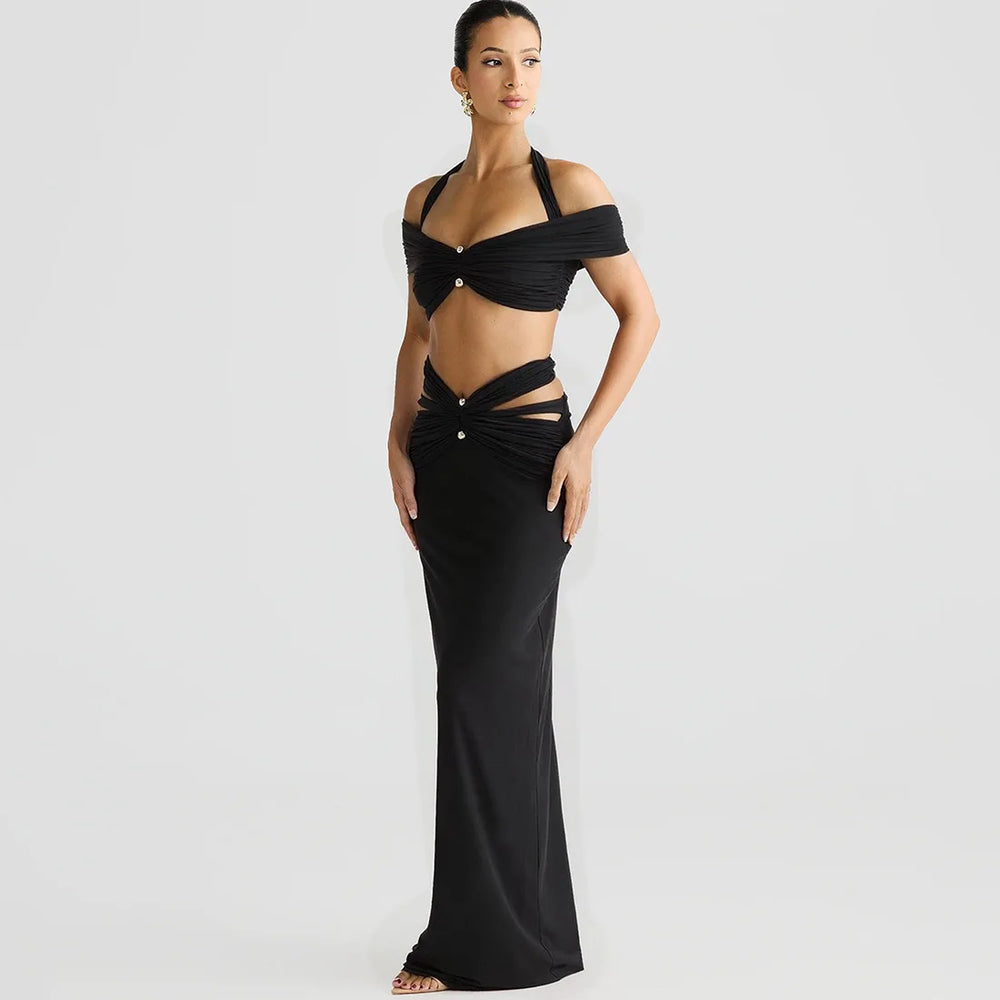 Woman wearing a black evening gown with cut-out design on a white background