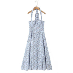 Floral dress on a hanger against a white background
