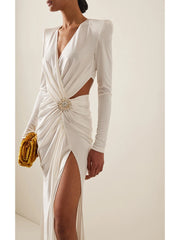 White evening gown with long sleeves and a cutout design, worn by a model against a neutral background.