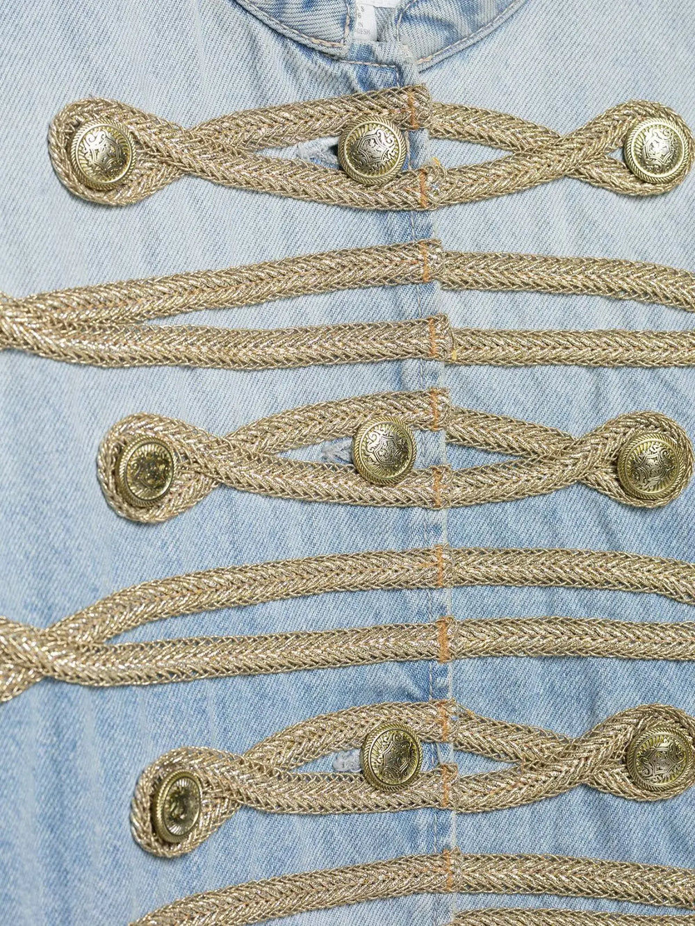 Close-up of the braided trim and buttons on the denim jacket.