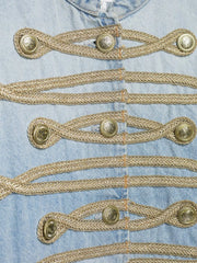 Close-up of the braided trim and buttons on the denim jacket.