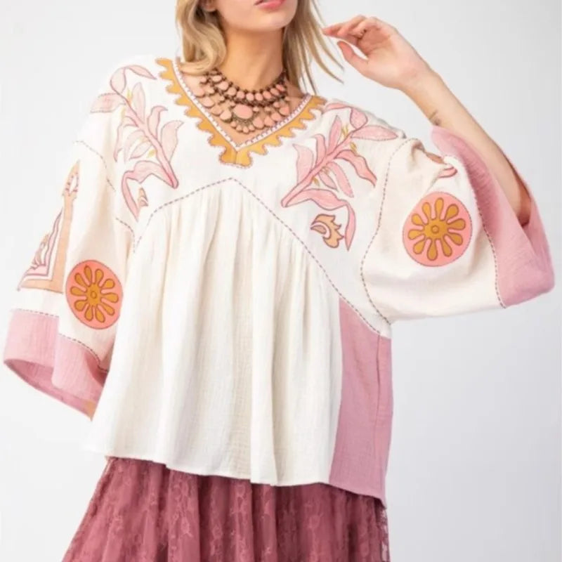 Embroidered V-neck flare sleeve top in ivory and pink.