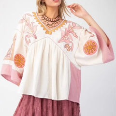 Embroidered V-neck flare sleeve top in ivory and pink.