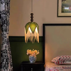 Artistic green petal fabric pendant light with beaded tassels in cozy vintage bedroom