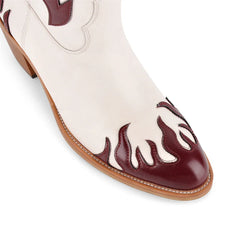 Detail of flame embellishment on toe of western flame embellished block heel boots