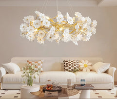 Modern chandelier with white flowers in a living room setting, featuring the brand 'artpad'.