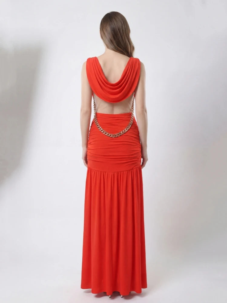 Red evening gown with chain detail on a white background