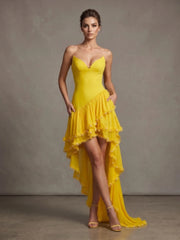 Model wearing a yellow ruffled pearl strapless dress
