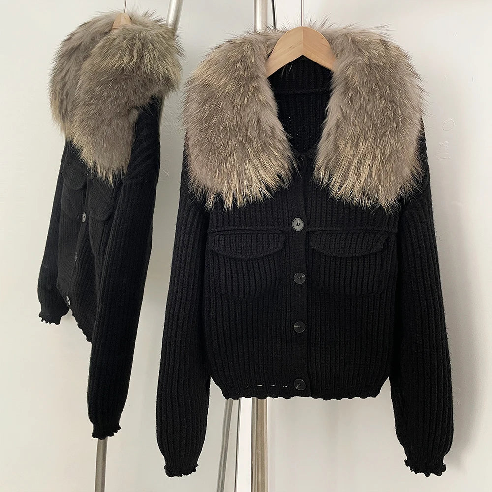 Black ribbed knit jacket with a large natural grey/brown fur collar.