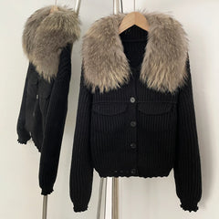 Black ribbed knit jacket with a large natural grey/brown fur collar.