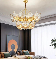 Luxury chandelier in a modern living room with a sofa and decorative wall art.
