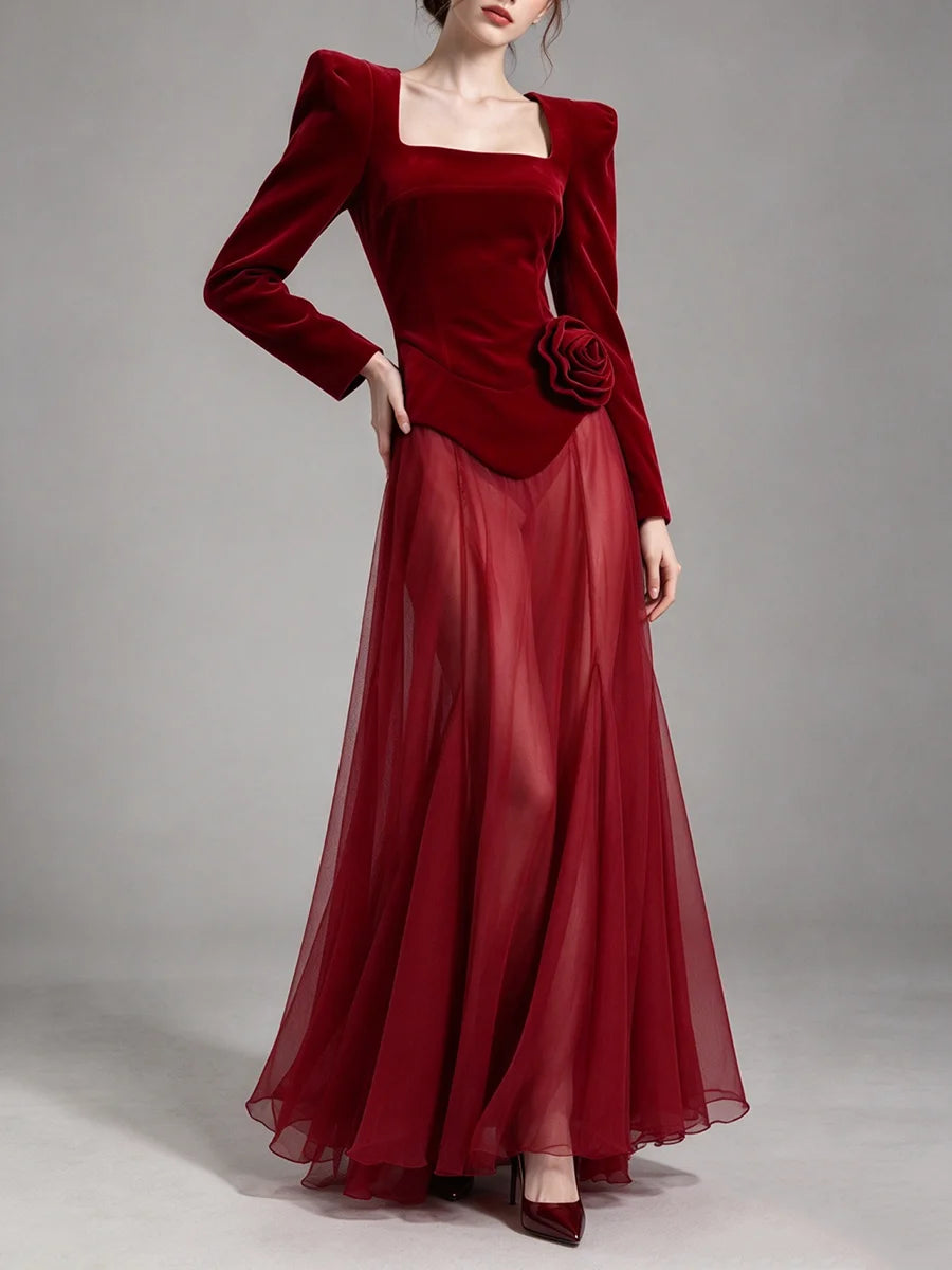 Maxi dress with structured shoulders and sheer skirt