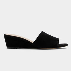 Black wedge heel open toe mules on a white background